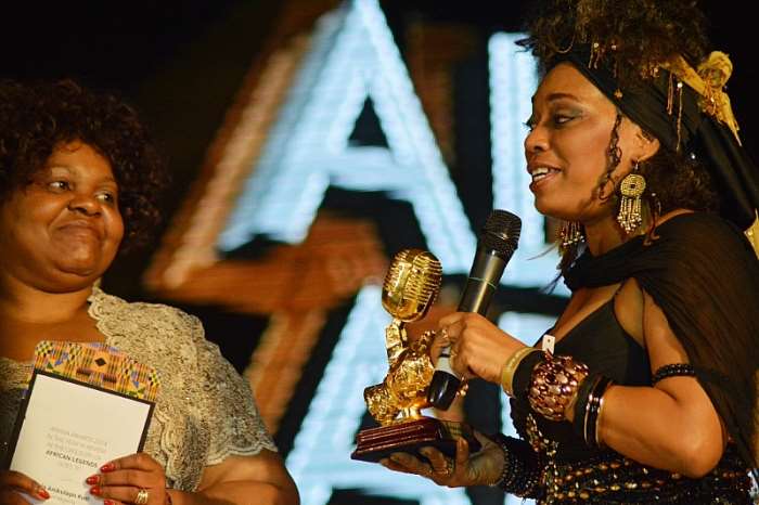 L-R: Head of culture and social affairs, African Union Commission, Mrs. Angela Martins presenting the AFRIMA Legend Award won by Fela Anikulapo Kuti to his daughter, Yeni Kuti, at the 2014 AFRIMA awards ceremony held at Grand Ballroom, Oriental Hotel, Lagos recently.