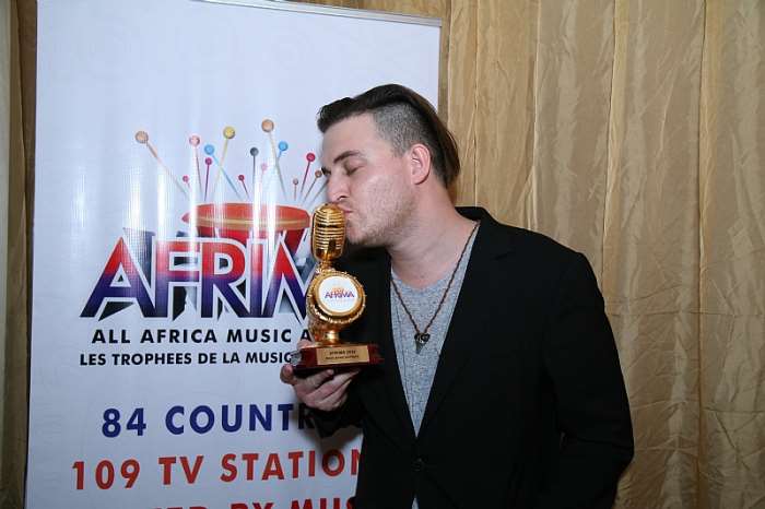 Dear Zim from Zimbabwe winner of the Best African Rock award kissing his trophy at the AFRIMA award held recently at the oriental Hotel, Victoria Island, Lagos, Nigeria