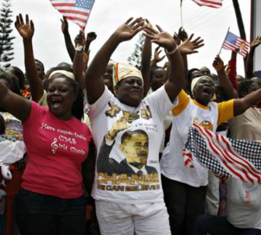 Ghanaians cheer and wave at the Obama motorcadePhotograph: Finbarr Oreilly/Reuters