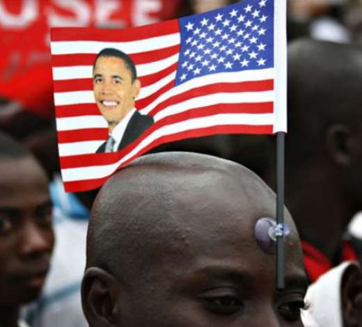 A man waits to catch a glimpse of ObamaPhotograph: Finbarr Oreilly/Reuters