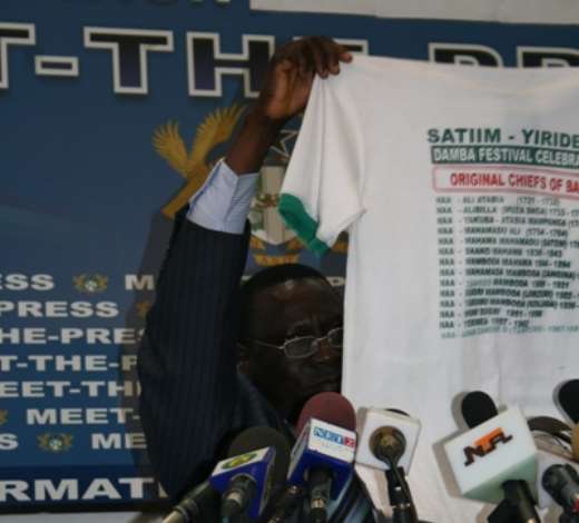 Mr John Tia Akologu, Minister of Information showing a T-shirt which concerns Bawku to the media.