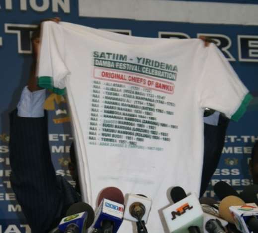 Mr John Tia Akologu, Minister of Information showing a T-shirt which concerns Bawku to the media.
