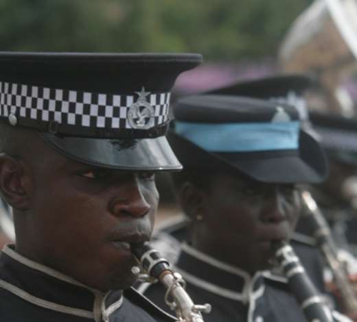 A POLICE SAXOPHONIST AT A PARADE GROUNDS