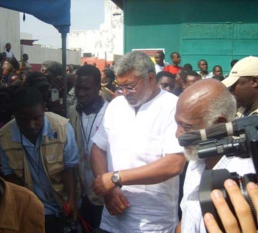Former President J.J. Rawlings waiting for his name to be checked on the                     voters register