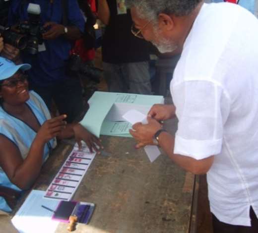 Former President J.J. Rawlings collects the presidential ballot paper