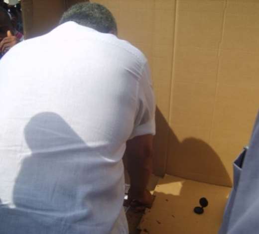 Former President J.J. Rawlings thumb-printing the presidential ballot paper
