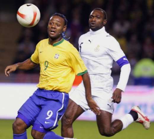 Brazils Vagner Love (L) runs for the ball with Ghanas John Mensah (R) during their friendly international football match at Rasunda Stadium in Stockholm, 27 March 2007. FREDRIK PERSSON/AFP/Getty Images