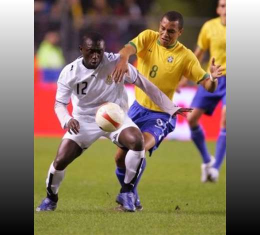 Ghanas Alex Tachie-Mensah, left, and Brazils Gilber Silva, right, battle for the ball during the Brazil versus Ghana friendly soccer match, Rasundra stadium, Stockholm, Sweden, Tuesday March 27, 2007.