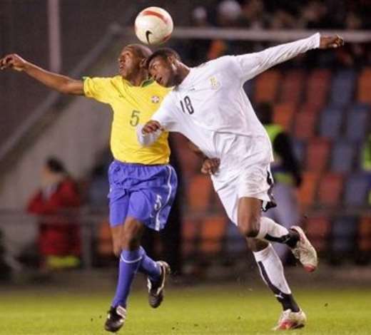 Brazils Mineiro, left, and Ghanas Eric Addo, right, try to head the ball during the Brazil versus Ghana friendly soccer match, Rasundra stadium, Stockholm, Sweden, Tuesday March 27, 2007.