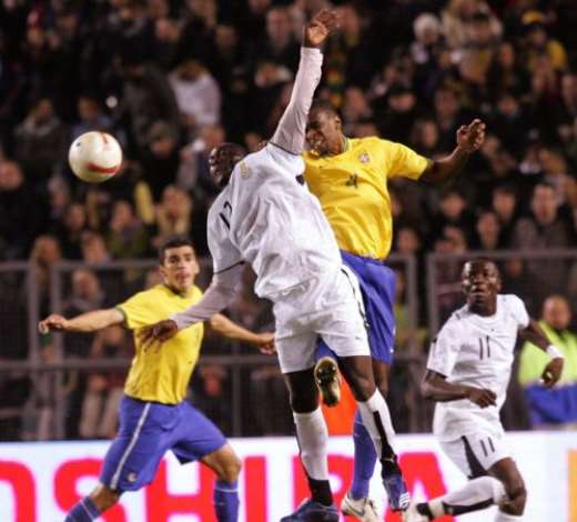 Brazils Juan (R) and Ghanas Alex Tachie-Mensah (L) jump for the ball during their friendly international football match at Rasunda Stadium in Stockholm, 27 March 2007. FREDRIK PERSSON/AFP/Getty Images