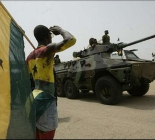 A man salutes soldiers during a parade for the 50th anniversary of the countrys independence in Accra. Ghanaians turned out in their thousands for the colourful celebrations.(AFP/Kambou Sia)