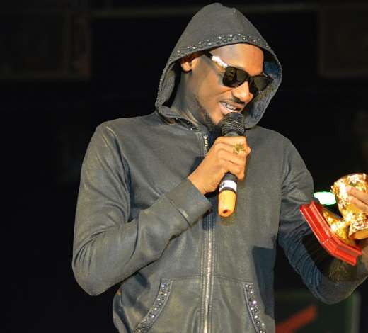 2Face from Nigeria admiring his Best RnB award trophy endorsed by Channel O at the 2014 AFRIMA award at the Grand Ballroom, Oriental Hotel, Victoria Island, Lagos recently