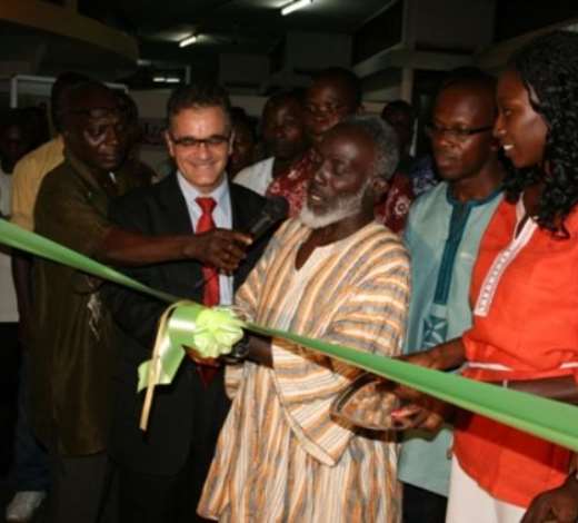 Mr Nana Yaw Poku Dankwa, Director of Ministry of Chieftaincy and Culture, cutting the tape to exhibit paintings, textiles and sculptures with some of the Executives of (GAVA).