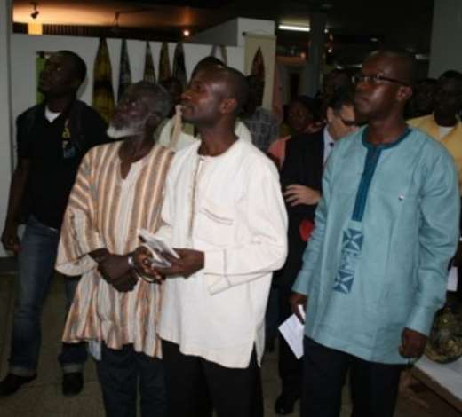 Mr Nana Yaw Poku Dankwa (left), Director of Ministry of Chieftaincy and Culture, looking at the exhibited items. With him are Mr Yaw Mensah, (middle) an artist and Mr Franklyn Glover, President of Ghana Association of Visual Artists (right)