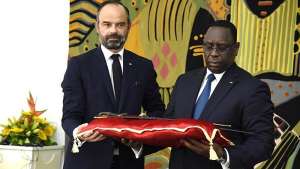 French Prime Minister Edouard Philippe symbolically handing over to Senegalese President Macky Sall the sword of Omar Sadou Tall, who led resistance against the French in 1857-1859.