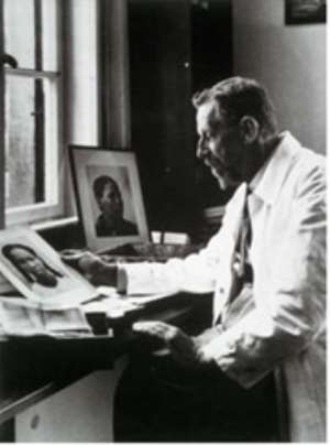 The evil Dr.Eugen Fischer whose pseudo-scientific theories of racial purity were practised on Namibians at his desk with photos of African women.