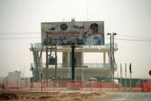 A billboard showing an image of Libyan military strongman Khalifa Haftar is erected on top of a military building.  By Abdullah DOMA (AFP/File)
