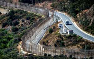 A border fence encircles Spains North African enclave of Ceuta which lies on the Strait of Gibraltar, surrounded by Morocco.  By FADEL SENNA (AFP)