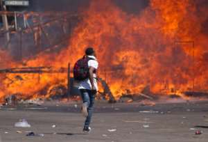 A burning barricade at a protest in Harare on August
