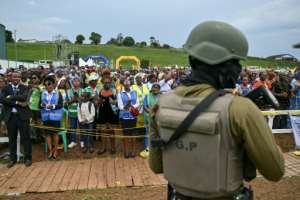 A Cameroonian soldier stands guard as the pope leads mass at Bamenda Airport.  By Alberto PIZZOLI (AFP)