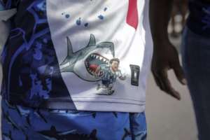 A Cape Verde supporter wears clothes depicting Argentinas Lionel Messi being chased by a shark, during celebrations in Praia.  By Jose Correia (AFP)