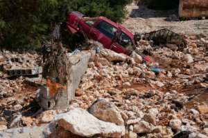 A car buried in post-flood rubble and debris in Al-Bayda in eastern Libya.  By - (AFP)