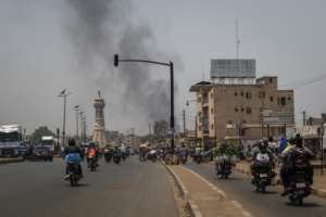 A column of black smoke rises above buildings in Bamako on April 26, 2026.  By - (AFP/File)