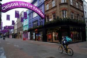 A cyclist rides down a near-deserted Carnaby Street in London, where residents continue to live under a strick lockdown.  By Niklas HALLEN (AFP/File)