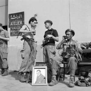 A file photo from November 1, 1956 shows Egyptian soldiers with a portrait of then president Gamal Abdel Nasser in Port Said at the height of the Suez canal crisis, after Nasser nationalised the key waterway.  By STR (FILES) (INTERCONTINENTALE/AFP/File)