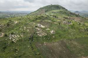 A line of hikers snakes up a rocky outcrop on the outskirts of Abuja, Nigeria.  By OLYMPIA DE MAISMONT (AFP)