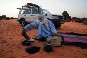A local tour guide sets up camp in the desert near Djanet.  By - (AFP)