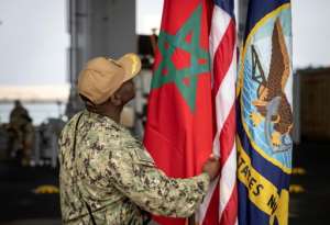A Member of the US Navy checks the Moroccan flag on the US navys ship Hershel Woody Williams during the African Lion military exercise, on June 11, 2021 in the Moroccan city of Agadir.  By FADEL SENNA (AFP)