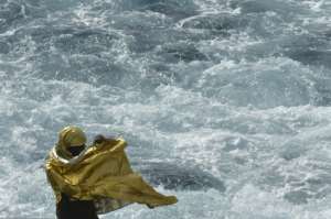 A migrant wrapped in a survival foil blanket stands aboard the Topaz Responder ship, run by Maltese NGO Moas and the Italian Red Cross, while sailing to the port of Vibo Valentia, southern Italy, after rescue missions off the Libyan coast