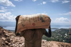 A miner in Luhihi hauls away spoil which will be carefully sifted for specks of gold.  By ALEXIS HUGUET (AFP)