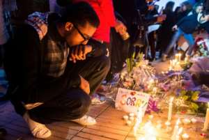 A Moroccan man places a candle during a vigil for the two Scandinavian hikers, who were killed in Moroccos High Atlas mountains, outside the Danish Embassy in Rabat on December 22, 2018.  By FADEL SENNA (AFP)