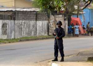 A policeman stands alert in front of The National Elections Commission