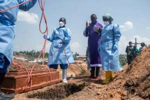 A priest and Red Cross members at the burial of an orphan who died from Ebola, at Mbiyo cemetery in Bunia, northeastern DR Congo.  By Jospin Mwisha (AFP)