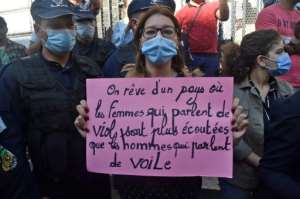 A protester demonstrating against femicide in Algeria held a sign reading in French, We dream of a country where women who talk about rape are heard more than men who talk about the veil.  By RYAD KRAMDI (AFP)