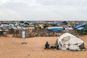 A refugee sits outside his tent at the Mbera refugee camp in Mauritanias Hodh Chargui region on April 27, 2026.  By PATRICK MEINHARDT (AFP)