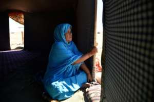 A Sahrawi refugee sits in her tent at the Boujdour camp in Algeria, just 50 kilometres (30 miles) away from her dispute homeland