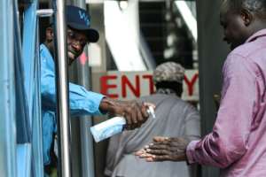 A security guard gives hand disinfectant for visitors to building in Nairobi, Kenya as eastern Africa reports its first cases.  By - (AFP)