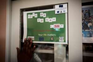 A sign that is part of a campaign to stop illegal migration from Ghana to Libya and Europe and to promote safe migration reads Its okay to say no to irregular migration..  By CRISTINA ALDEHUELA (AFP)