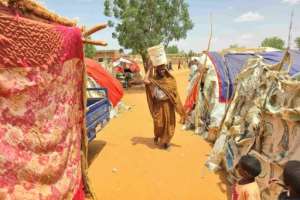 A Sudanese woman carrying a plastic canister in al-Rahmaniyah camp for displaced people near El-Obeid in Kordofan.  By - (AFP)