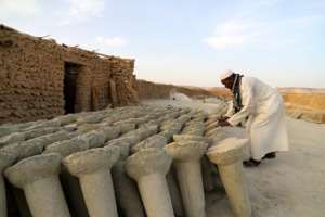 A trader in Bilma arranges salt slabs -- these ones are destined for animal consumption.  By Souleymane Ag Anara (AFP)