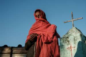 A woman who fled the Tigray conflict prays at an Ethiopian Orthodox church built near the Um Raquba refugee camp in Gedaref, eastern Sudan.  By Yasuyoshi CHIBA (AFP/File)