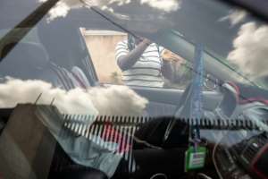 A woman who was trafficked to Europe talks to a taxi driver in Nigerias Benin City.  By Light Oriye Tamunotonye (AFP)