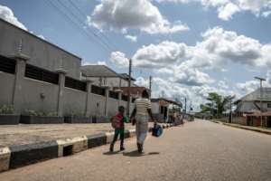 A woman who was trafficked to Europe walks hand in hand with her son in Benin City.  By Light Oriye Tamunotonye (AFP)