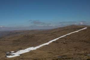 Afriskis main kilometre-long piste is a strip of brilliant white snow between brown grassy ridges.  By MARCO LONGARI (AFP)