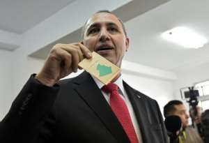 Algerian former culture minister Azzedine Mihoubi casts his vote.  By RYAD KRAMDI (AFP)