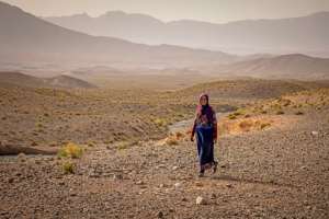 Amazigh woman Ida Ouchaali walks at an encampment near the village of Amellagou where Moroccos last nomads live.  By FADEL SENNA (AFP)